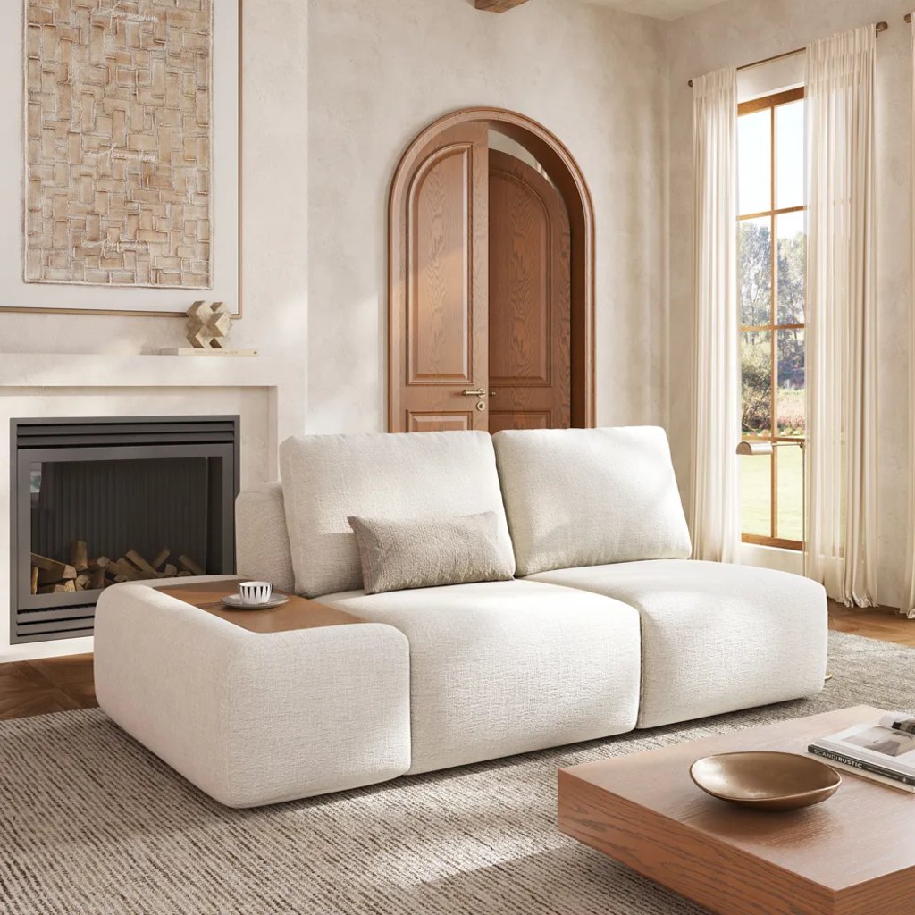 White modular loveseat with a built-in wood side table in a bright living room.