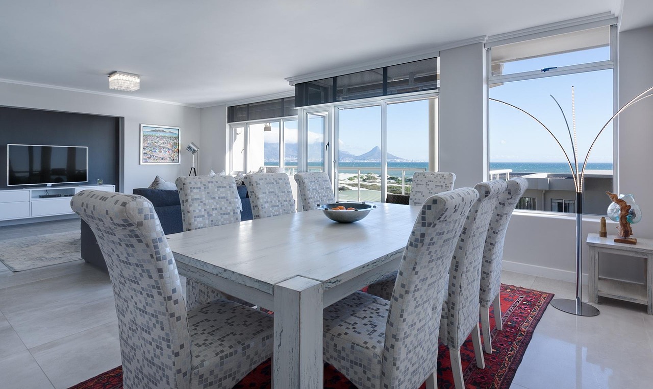 Modern dining room with rectangular table, bright windows, contemporary furniture