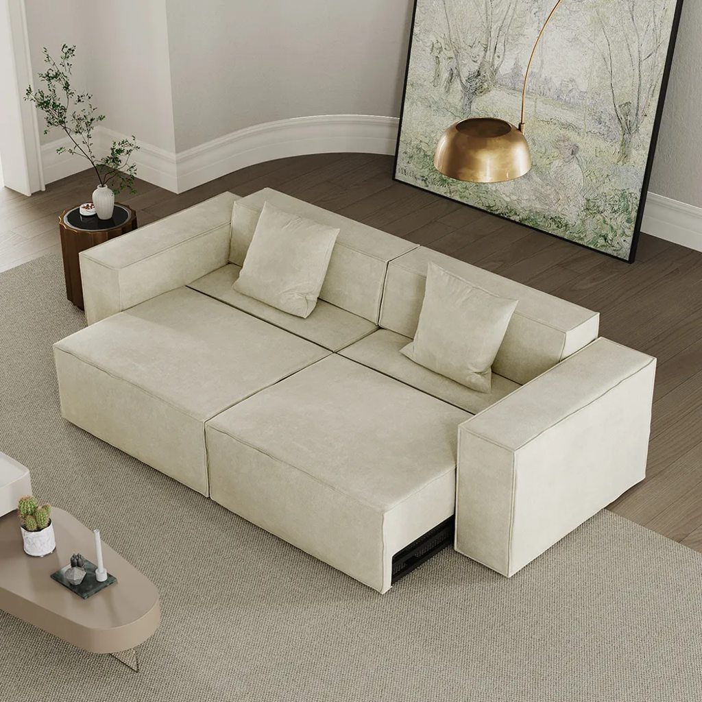 Cream modular sofa bed extended into a wide sleeping platform in a modern living room.