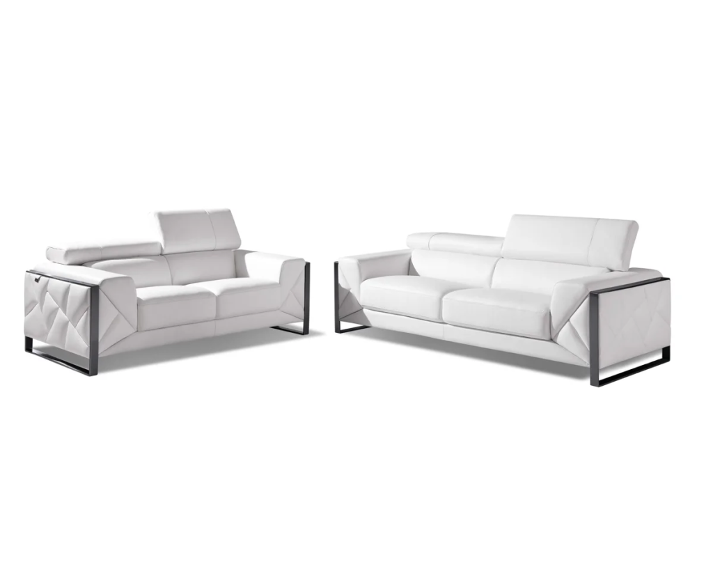 White leather sofa and loveseat with adjustable headrests and black metal frames on a white background