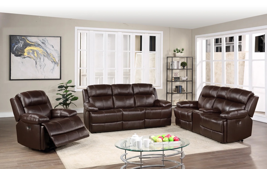 Dark brown leather power reclining sofa, loveseat, and chair arranged in a bright living room with a glass coffee table