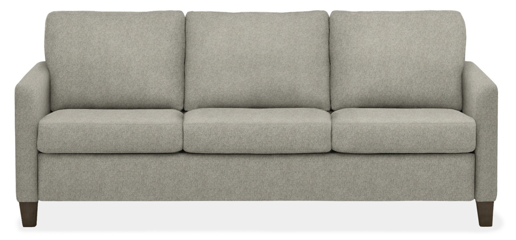 Light gray three-seat upholstered sleeper sofa with loose cushions and dark wooden legs on a white background