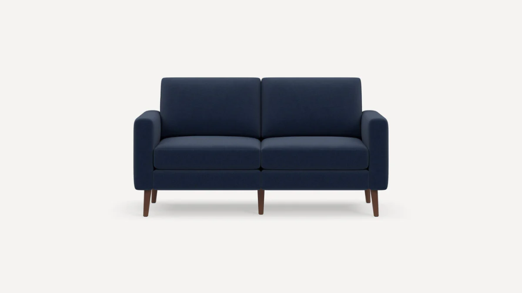 Compact navy blue loveseat with two seat cushions and tapered wooden legs