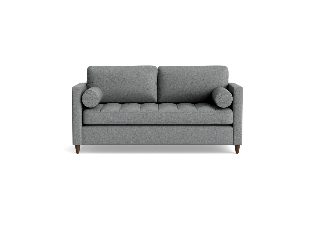 Gray compact sleeper sofa with a tufted bench seat and round bolster pillows on a black background