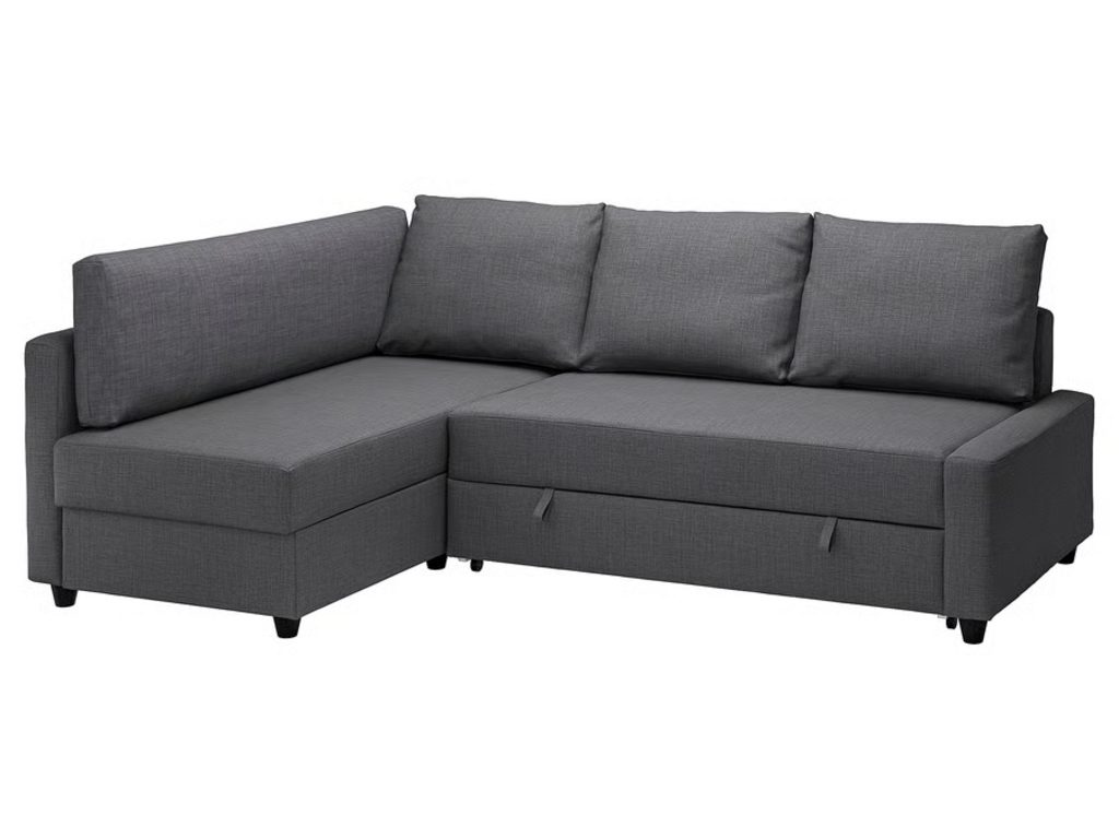 Dark gray sleeper sectional with a left chaise, pull-out bed section, storage compartment, and tapered black legs on a white background.