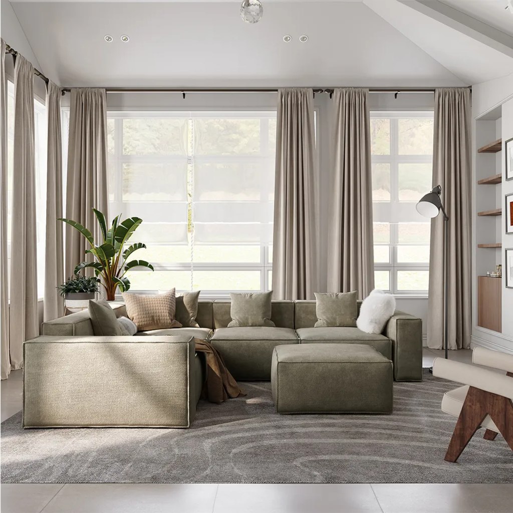 Large beige U-shaped modular sectional with an ottoman in a bright living room.