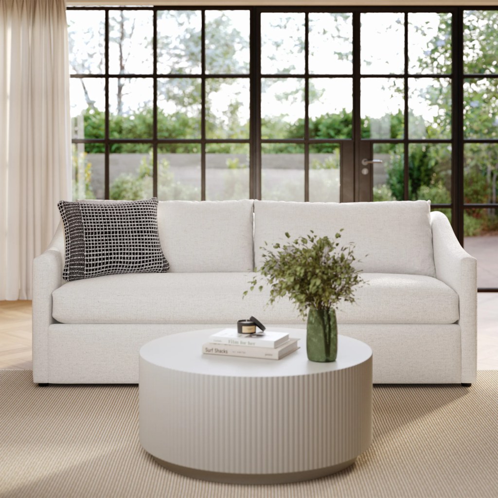 White upholstered sofa with supportive arms in a bright living room.