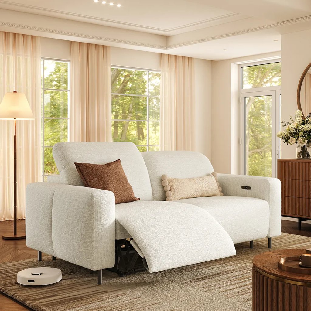 White dual power reclining loveseat with one footrest extended in a bright living room.