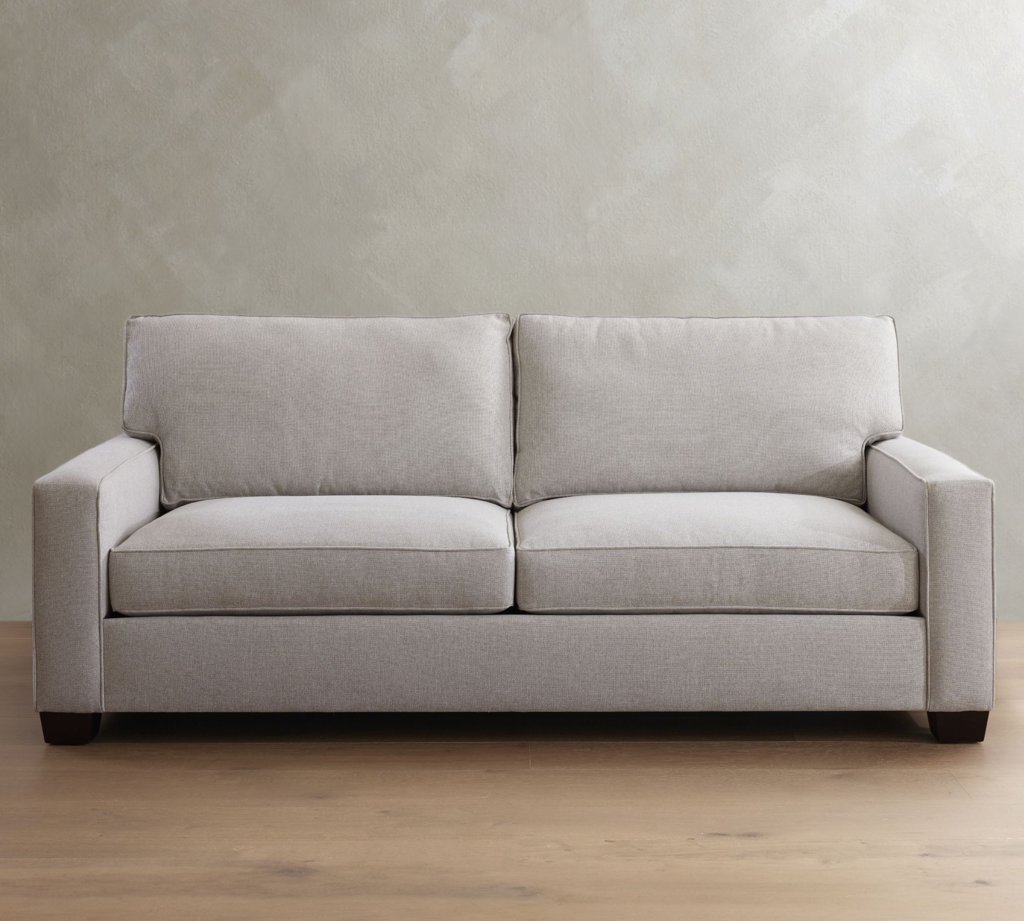 Gray high-seat sofa with square arms and supportive cushions against a neutral wall.