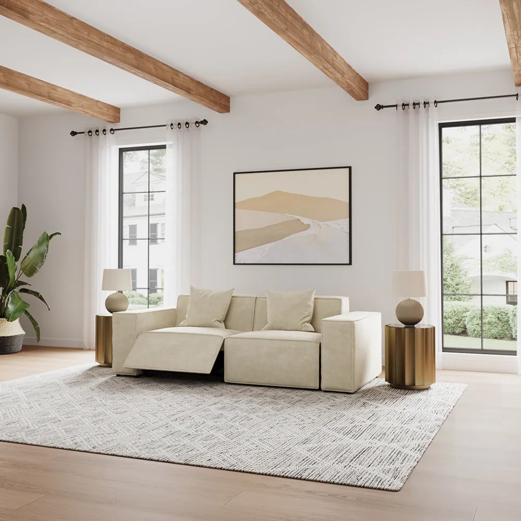 Beige power reclining loveseat with one footrest extended in a bright modern living room.