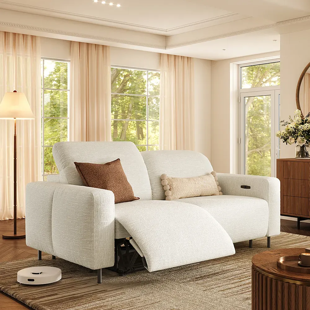 White dual power reclining loveseat with one footrest extended in a bright living room.