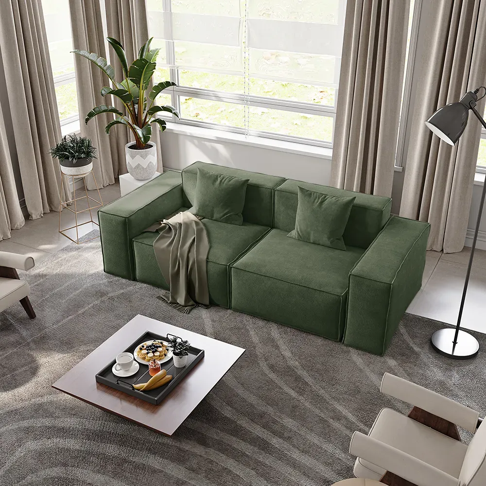 Green modular sofa in a bright family playroom with open floor space for children’s activities.