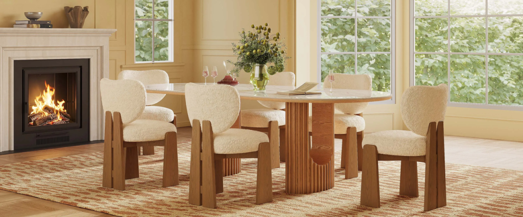 Cream bouclé dining chairs with solid wood frames arranged around a dining table.