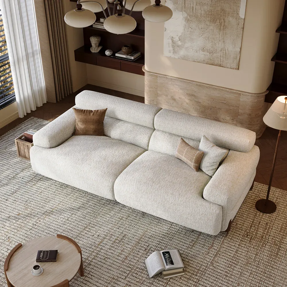 White deep-seat sofa with wide arms and supportive back cushions in a warm modern living room.