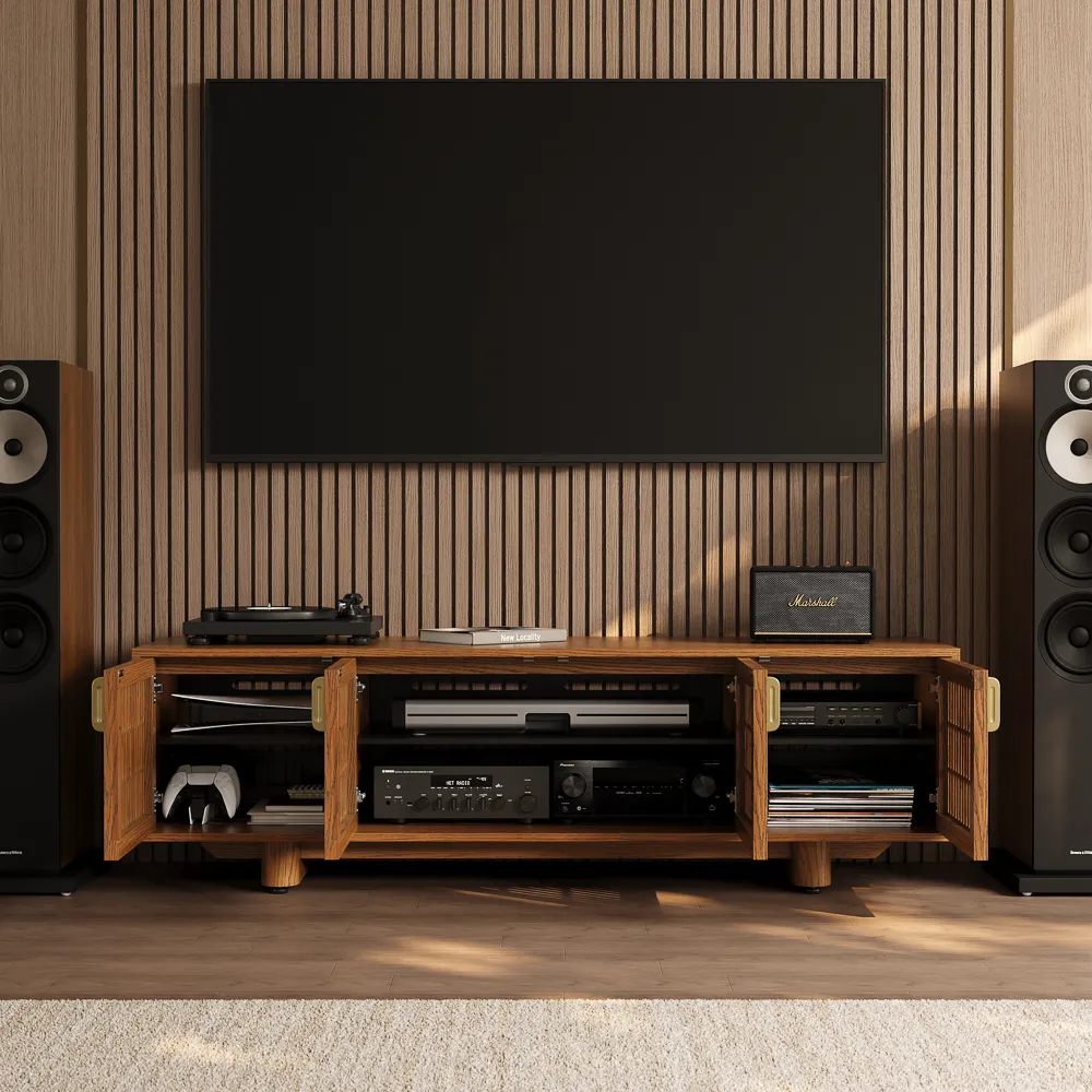 Wall-mounted TV above an open wood media console showing stored AV equipment, game controller, and organized entertainment center storage.