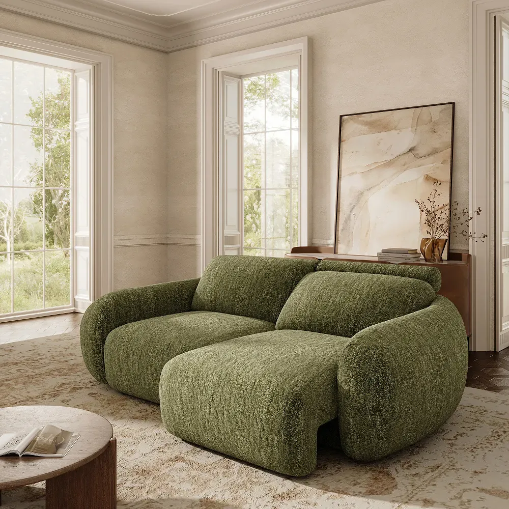 Green power sofa bed with an extended seat for daybed-style lounging in a bright living room.