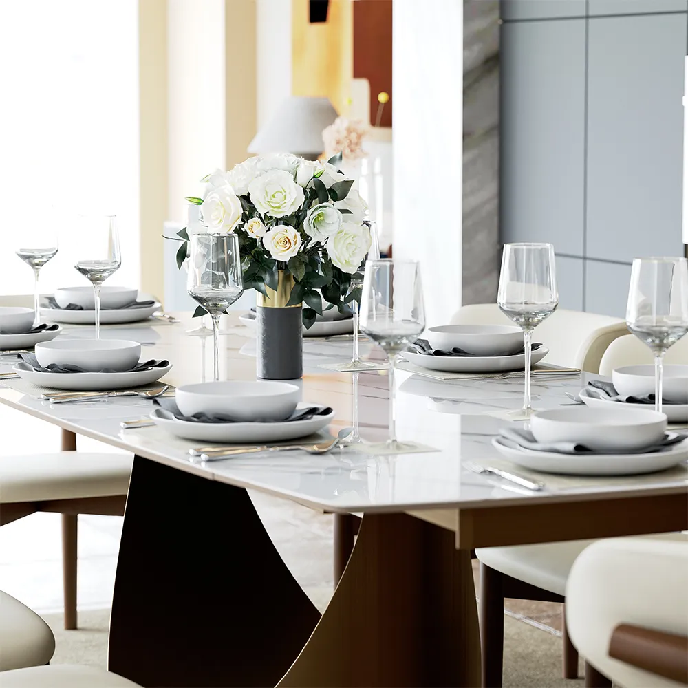 Extendable dining table set for six with white chairs, place settings, wine glasses, and a floral centerpiece.