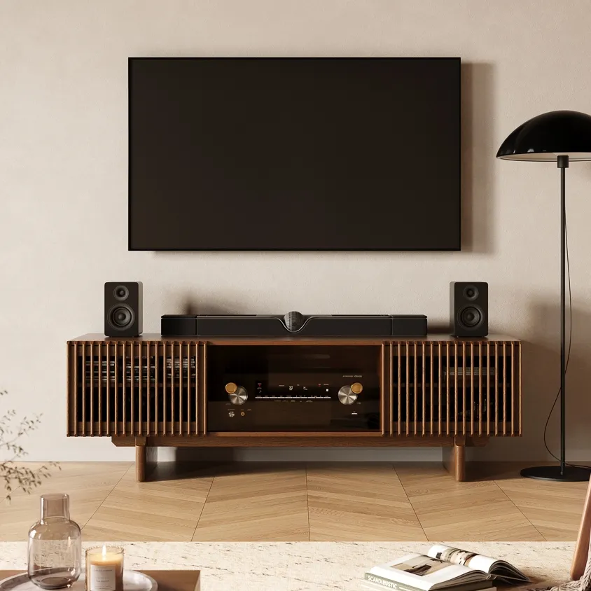 Minimal TV wall with slatted wood media console, hidden center components, and clean living room cable management setup.