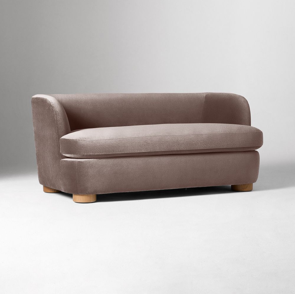Compact mauve loveseat with curved arms and a single bench cushion on a white studio background.