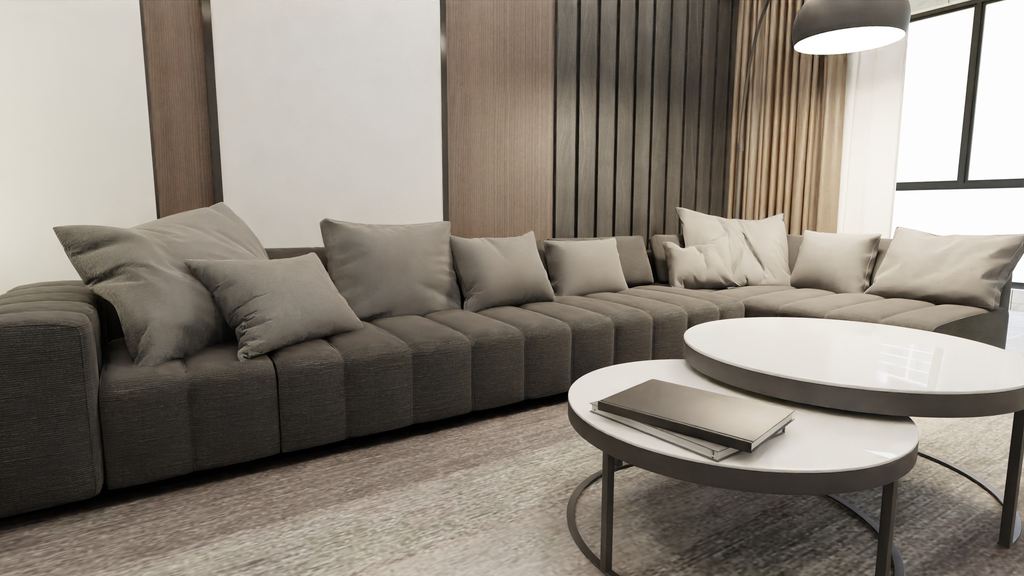 Two round nesting coffee tables in front of a large gray modular sectional sofa