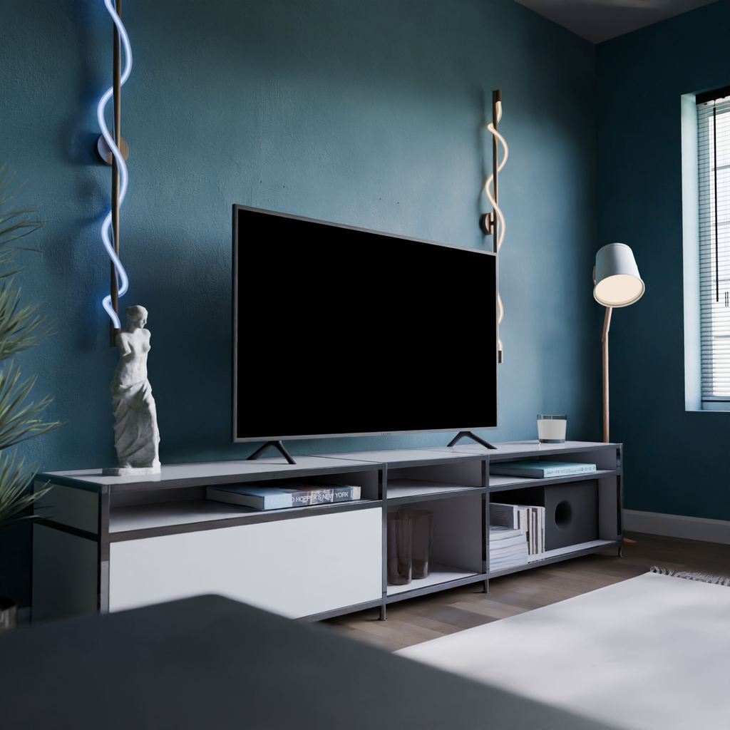 TV on a low-profile black and white media console with open shelves in a modern blue living room.