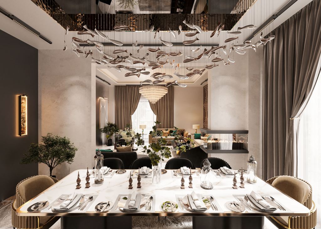 Large white stone dining table set for eight beneath sculptural pendant lighting in a luxury open-plan dining room.