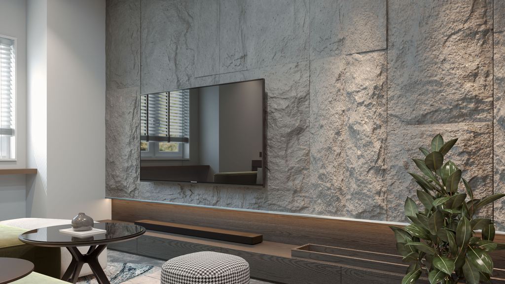 Wall-mounted TV on a textured gray stone feature wall above a dark wood media console, with a soundbar, round coffee table, ottoman, and large indoor plant in a modern living room.