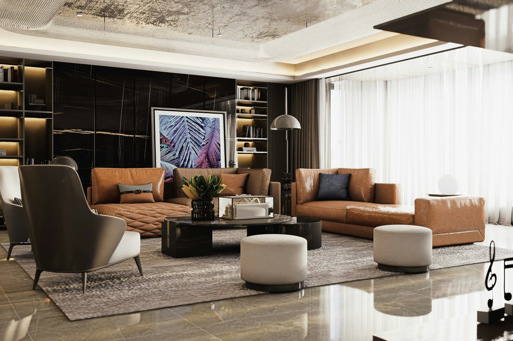 Caramel leather sofas arranged in a spacious modern living room with armchairs, ottomans, and a round coffee table