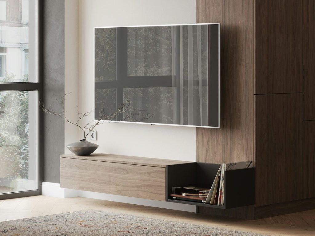 Wall-mounted TV above a floating light wood media console with open vinyl record storage, set beside a tall dark wood built-in cabinet in a modern living room.