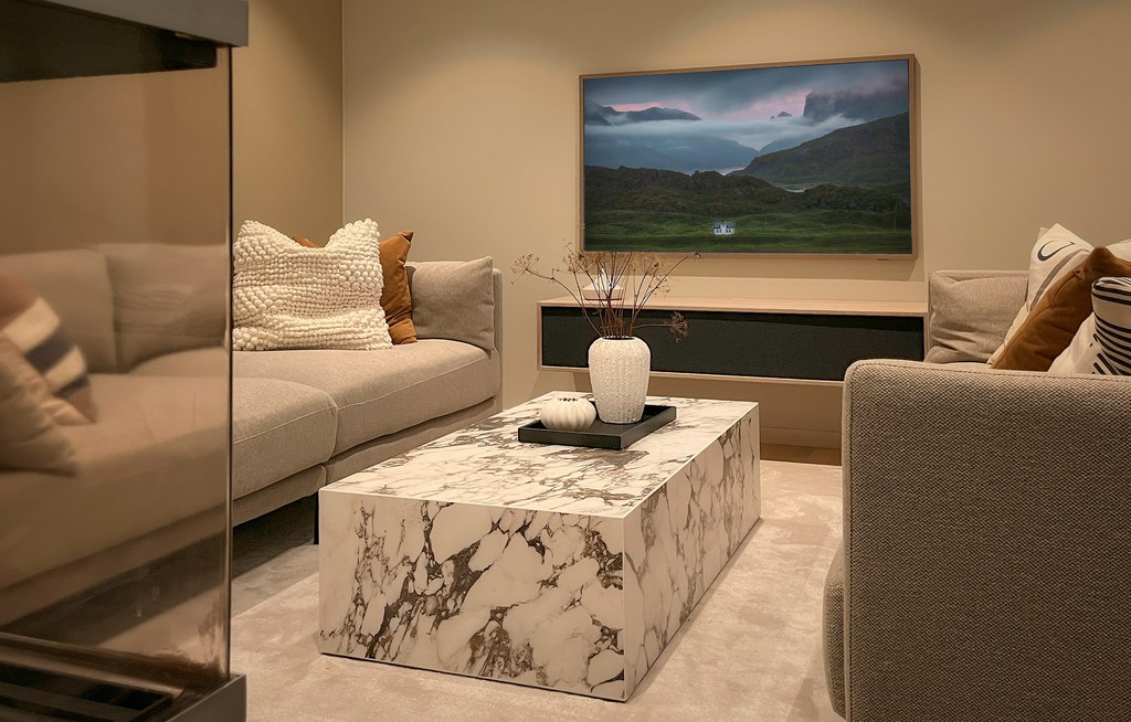 Rectangular marble coffee table between two neutral sofas in a modern living room