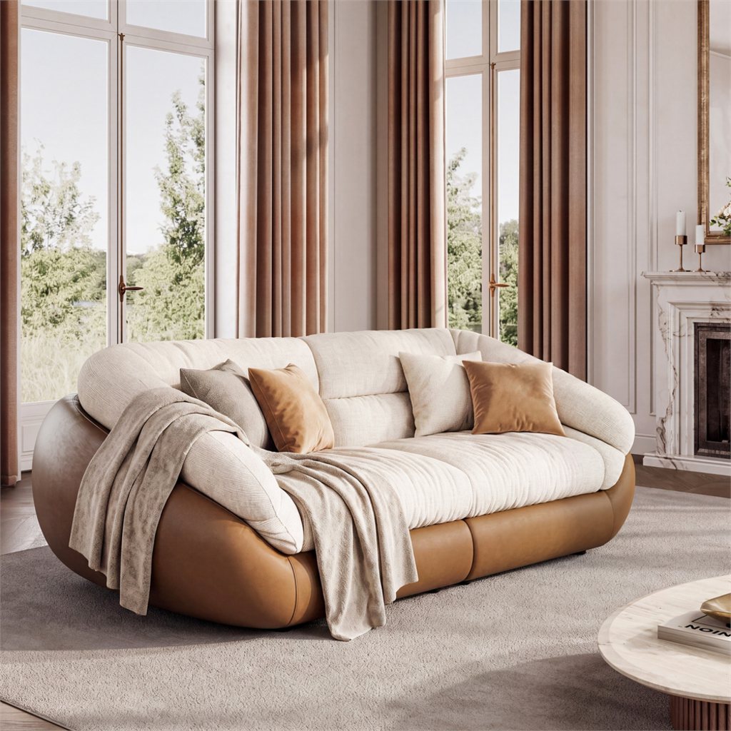 Low back cream sofa with rounded cushions and brown base in a bright living room with tall windows.