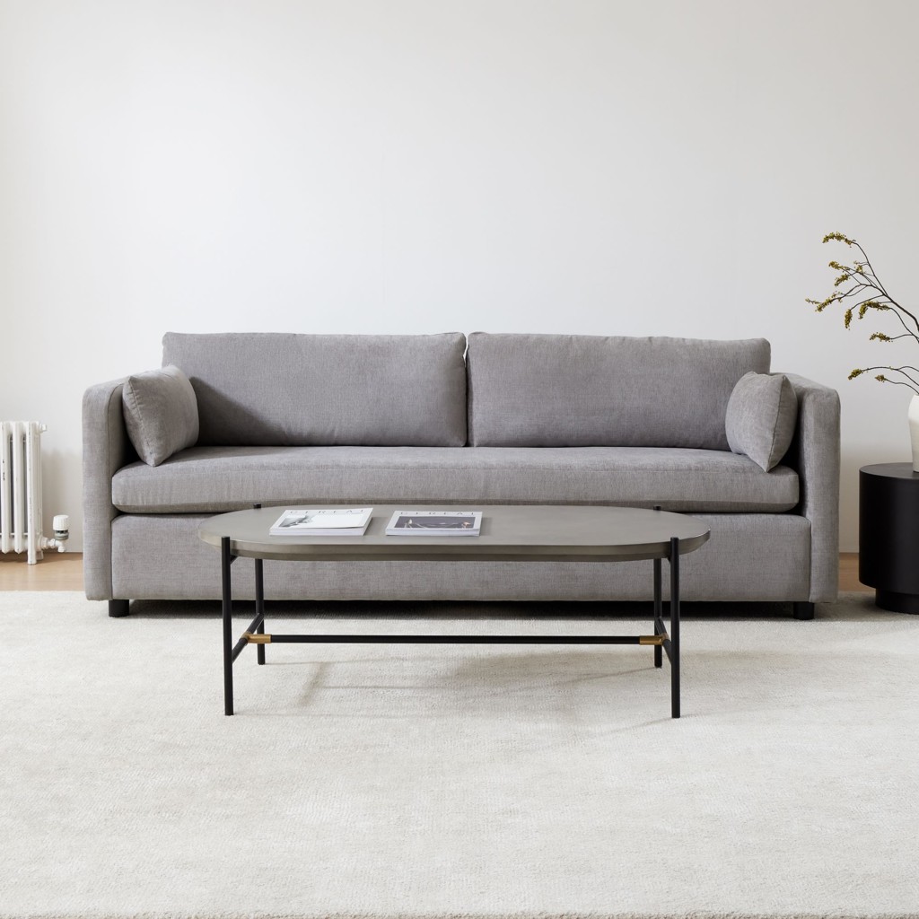 Gray sofa with a minimalist coffee table in a modern neutral living room.