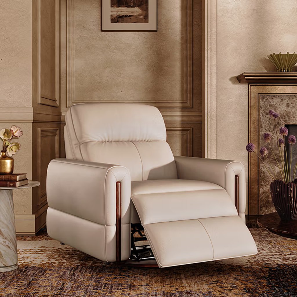 Light beige power recliner with extended footrest in a warm, elegant living room with a fireplace and neutral decor.