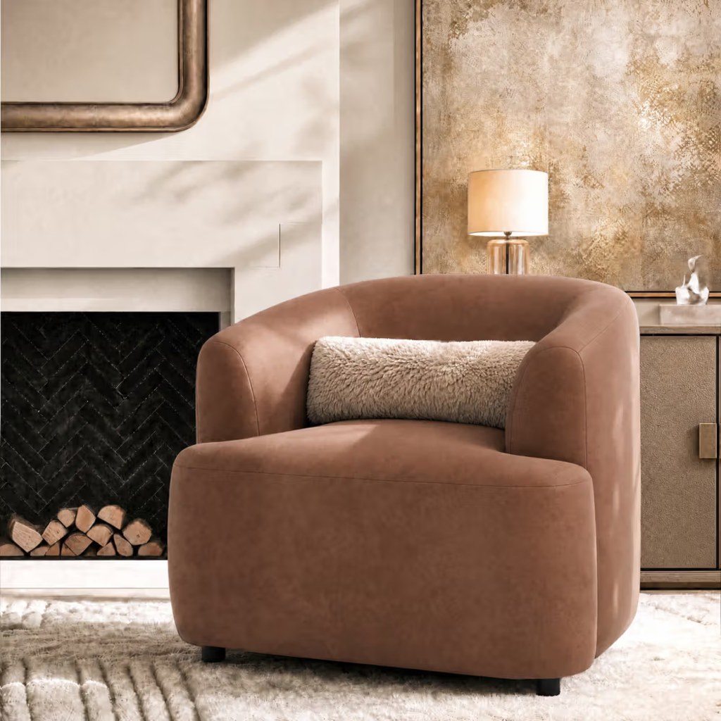 Brown upholstered armchair with a lumbar cushion beside a fireplace in a warm, modern living room.
