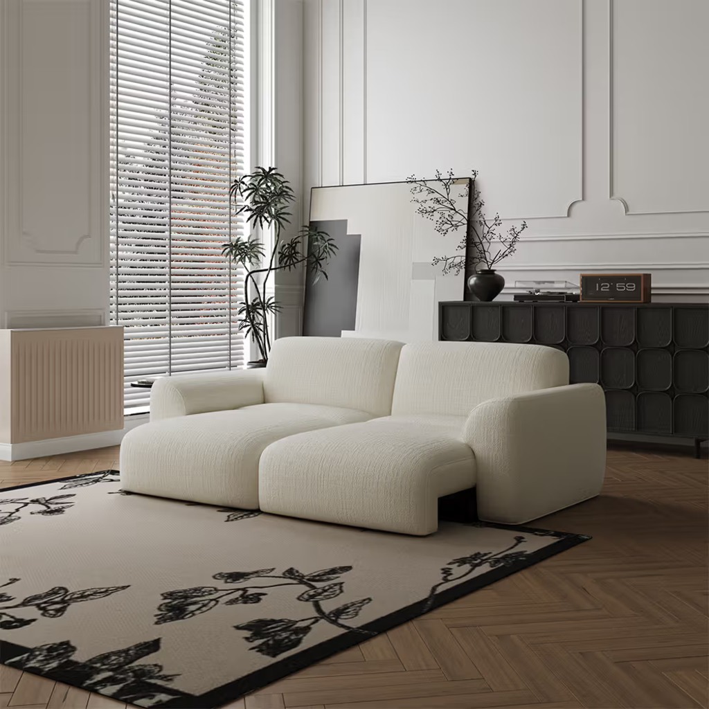 Cream power sleeper sofa with independently adjustable seat sections in a modern living room.