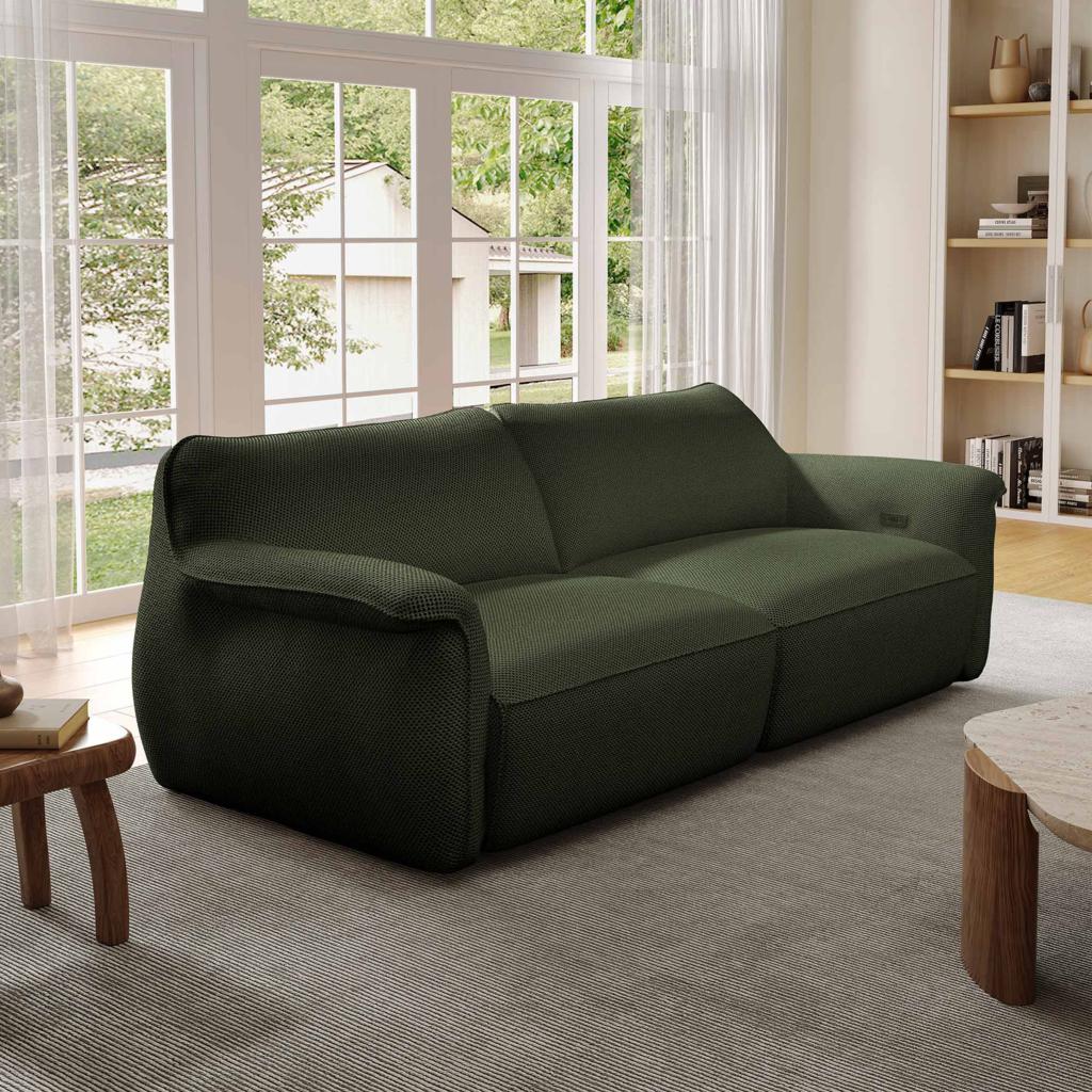 Dark green dual-section sleeper sofa in a bright modern living room with large windows.