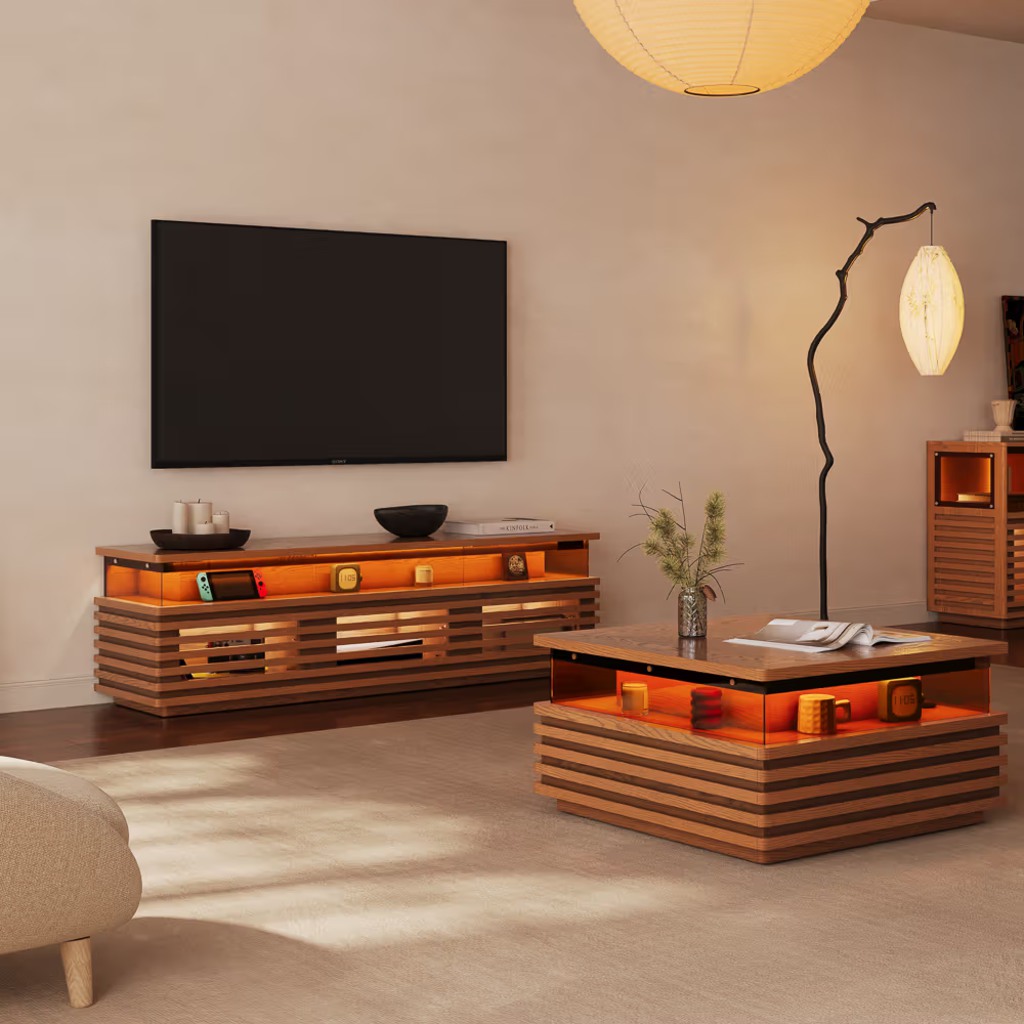 Modern living room with a wall-mounted TV, slatted wood media console, matching coffee table, warm ambient lighting, and minimalist decor.