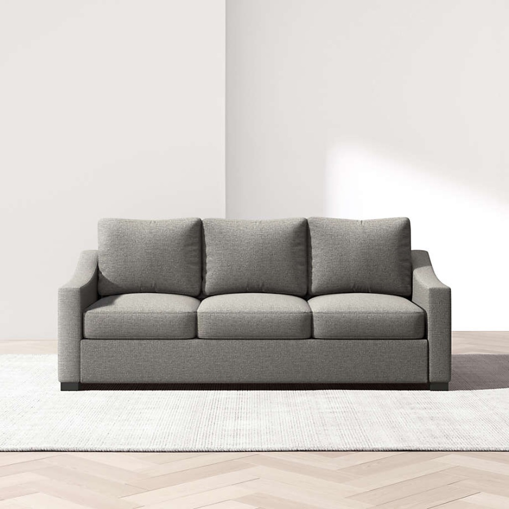 Gray three-seat sofa with matching cushions in a bright minimalist living room.