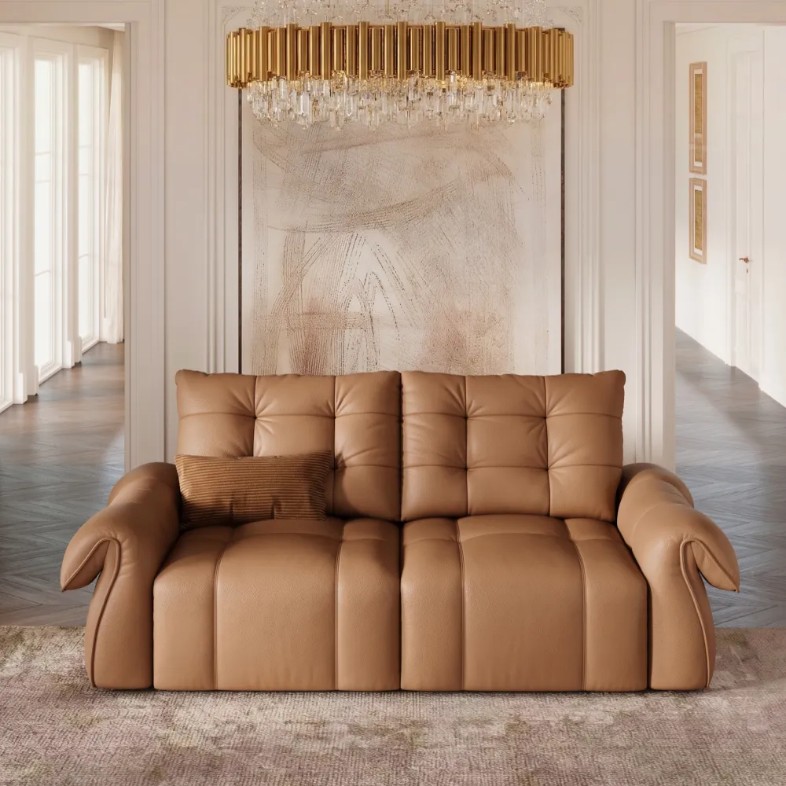 Brown leather power sofa bed in a bright modern living room with a gold chandelier.