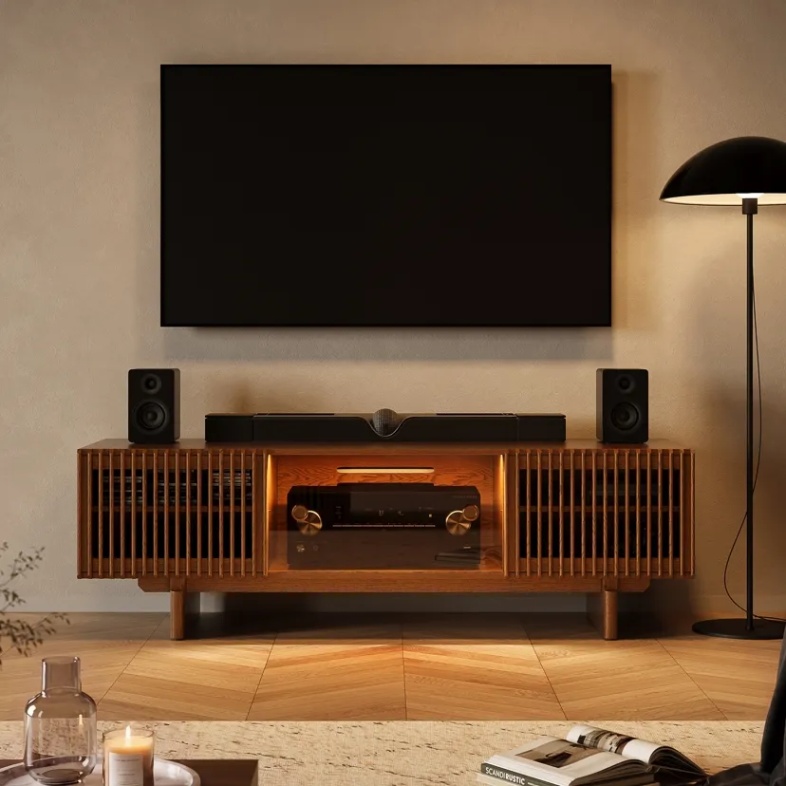 Wood media console with an AV receiver, soundbar, speakers, and wall-mounted TV.