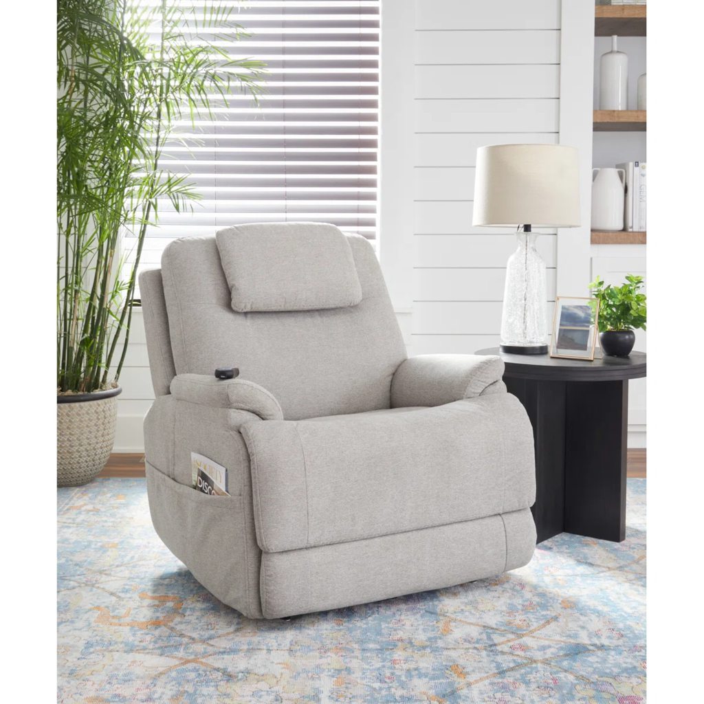 Light gray power lift recliner with a padded headrest and side pocket in a bright living room.