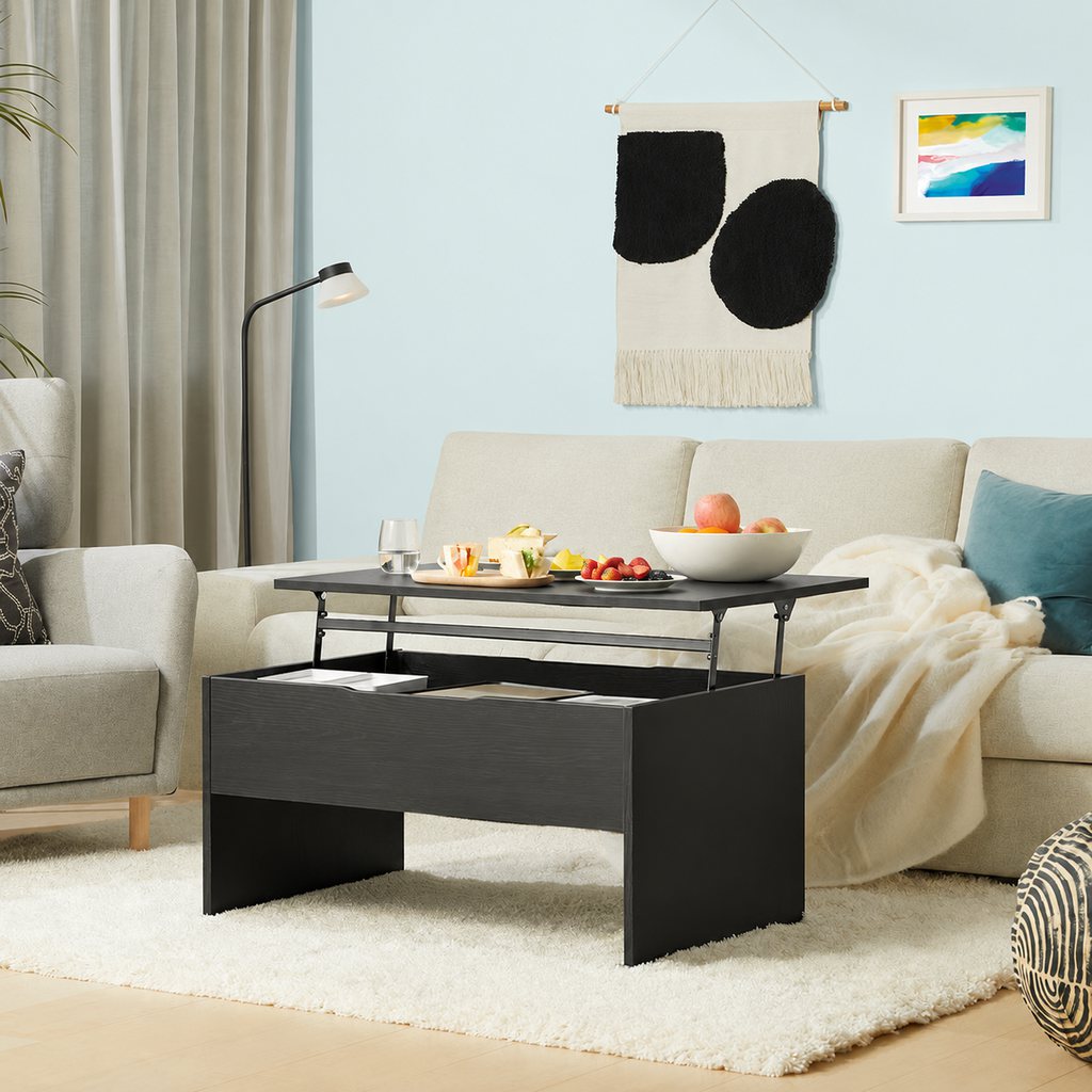 Black lift-top coffee table with snacks and hidden storage in front of a cream sectional sofa.