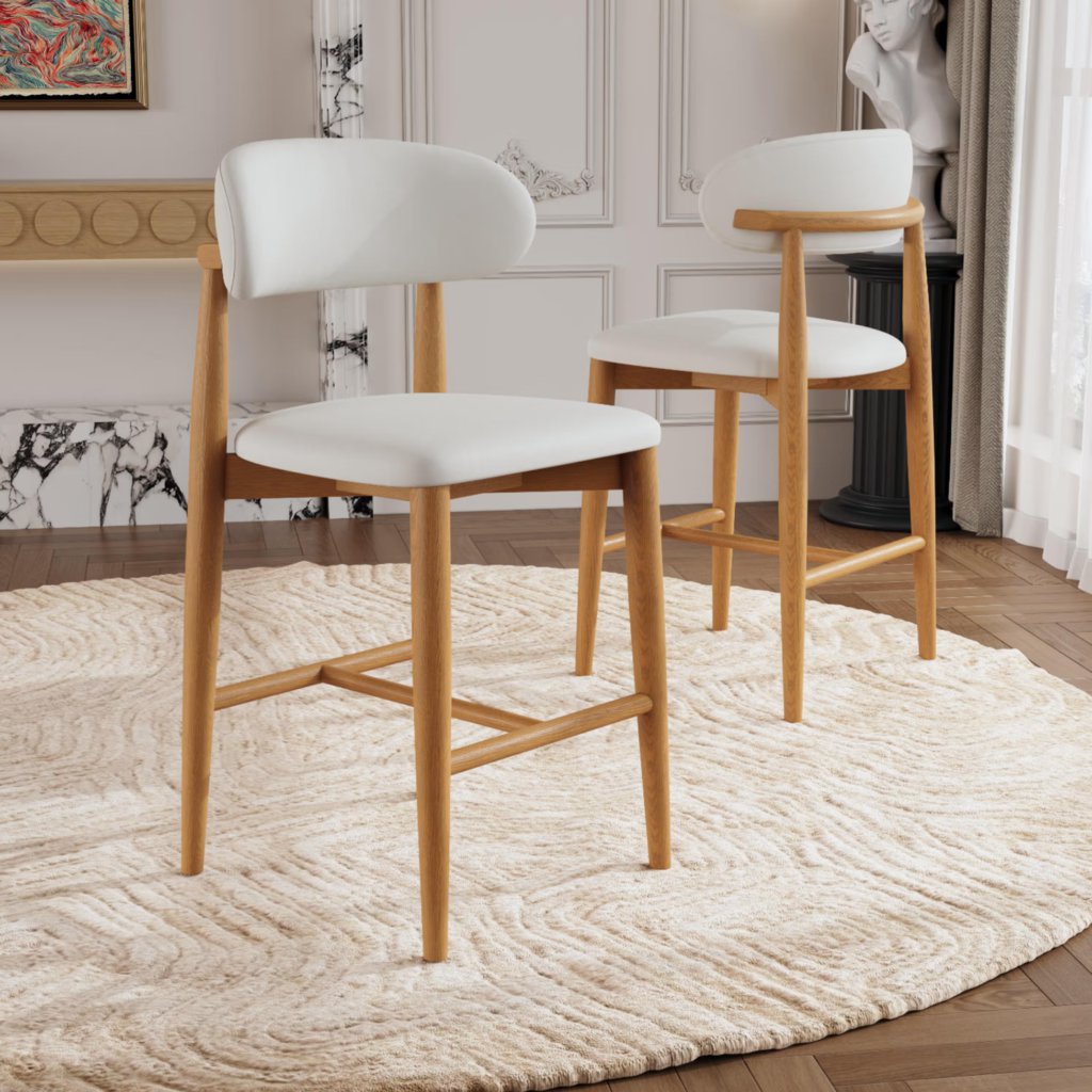 Two white upholstered counter stools with natural wood frames and curved backs in a modern dining area.