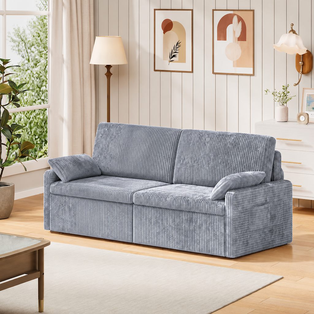 Light gray-blue corduroy sleeper sofa in a bright modern living room with neutral decor.