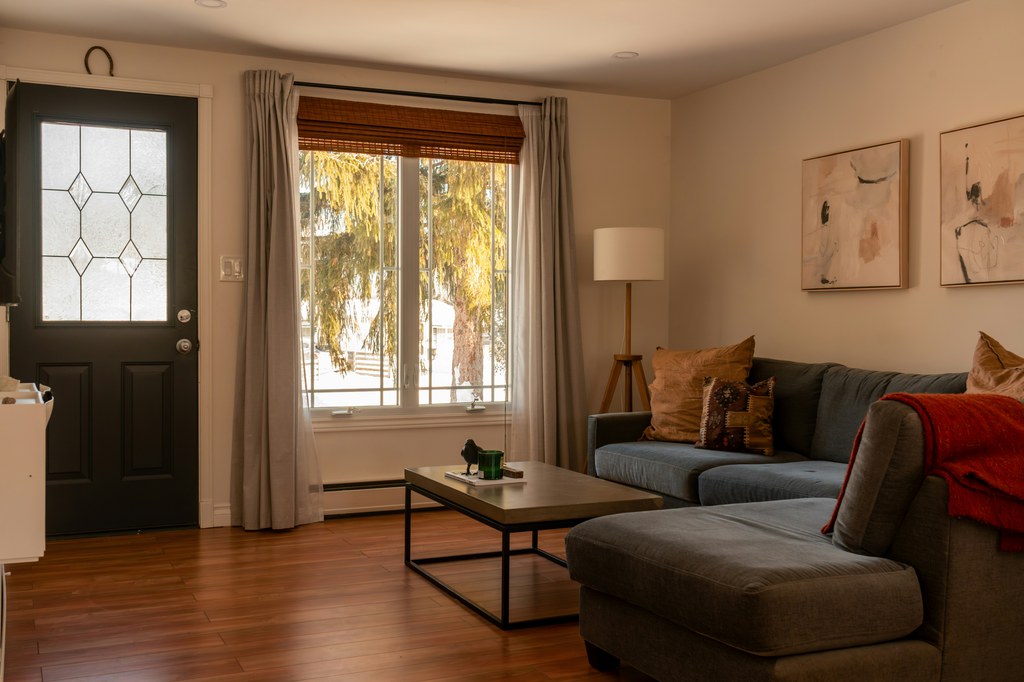 Gray sectional sofa with chaise and rectangular coffee table in a warm living room.
