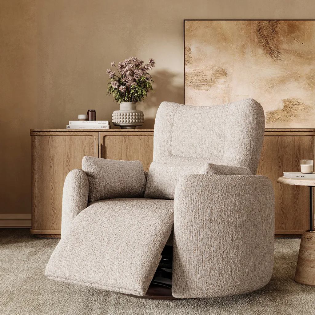 Cream high-back swivel recliner with an extended footrest and lumbar pillows in a neutral living room.