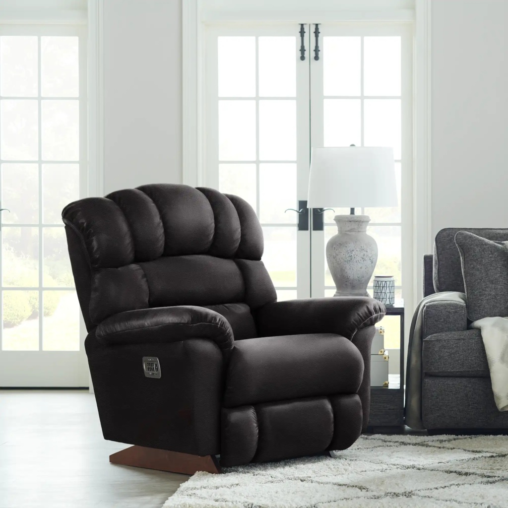 Dark brown high-back power recliner with padded arms in a bright living room.