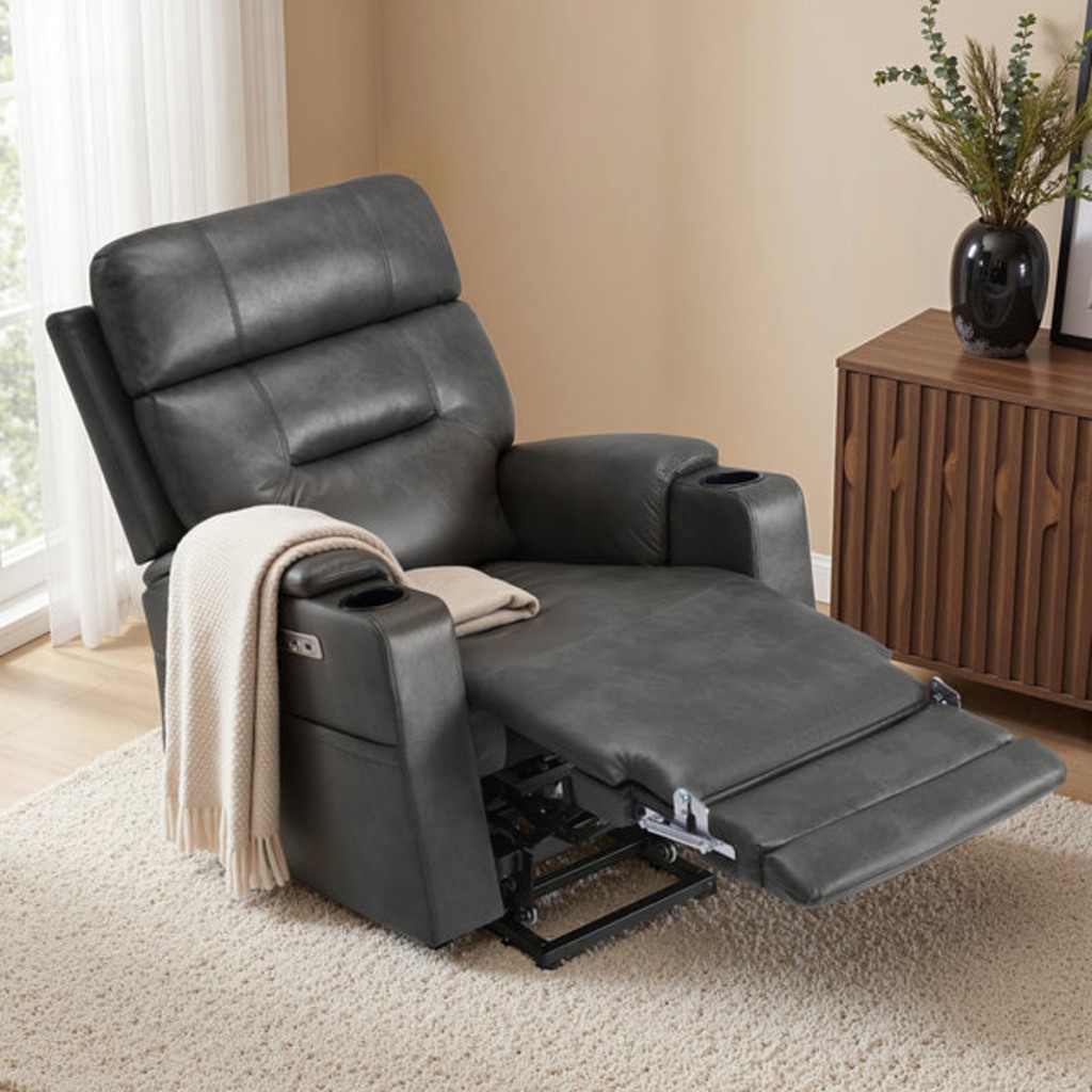 Gray high-back power lift recliner with an extended footrest, cup holders, and side storage in a living room.