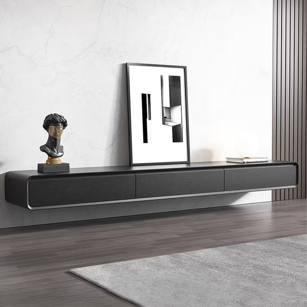 Black wall-mounted floating TV stand with three closed compartments in a minimalist modern living room.