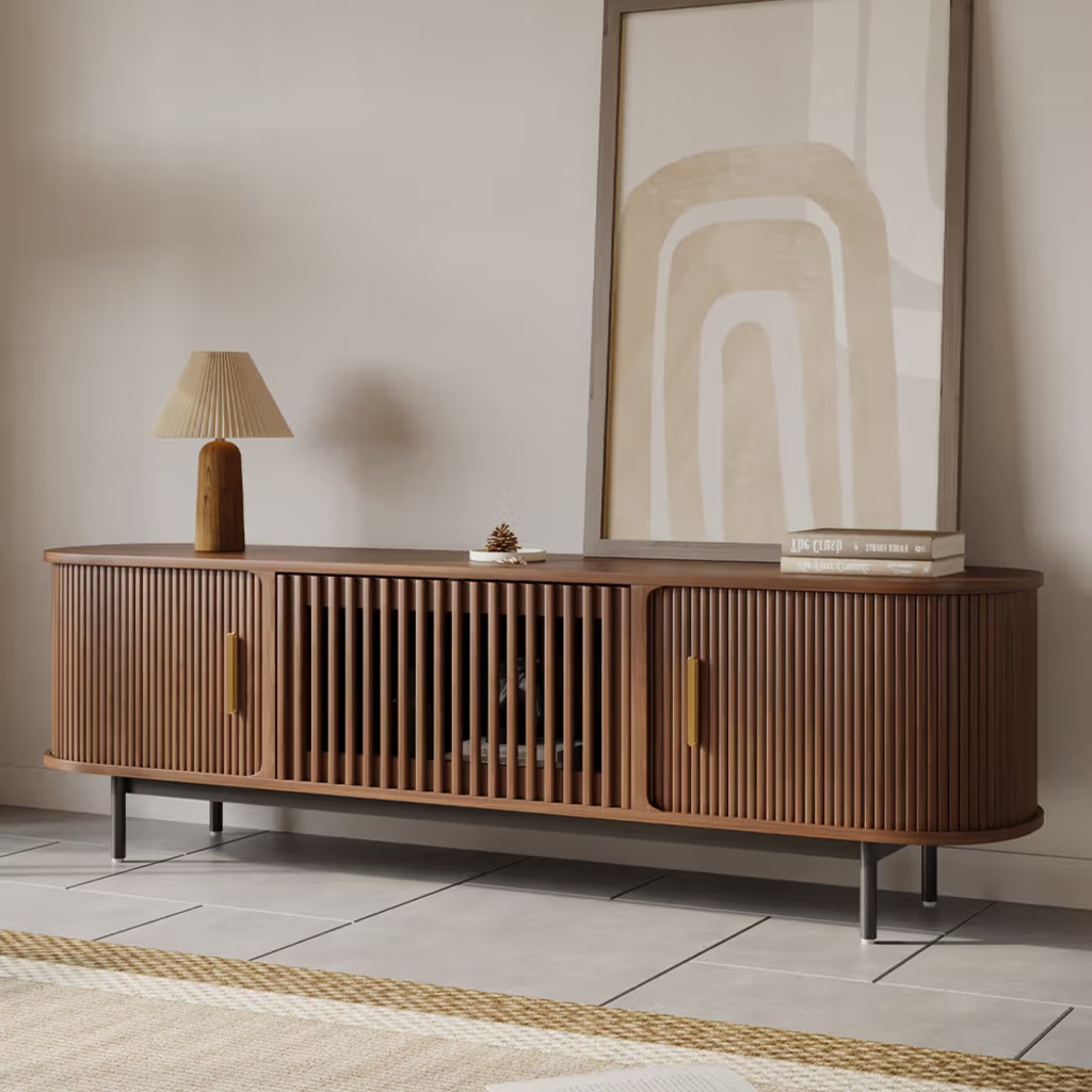 Walnut slatted media console with rounded doors and open center storage in a modern living room.